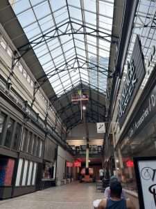 Aerial lift used for electrical work inside a historic marketplace atrium