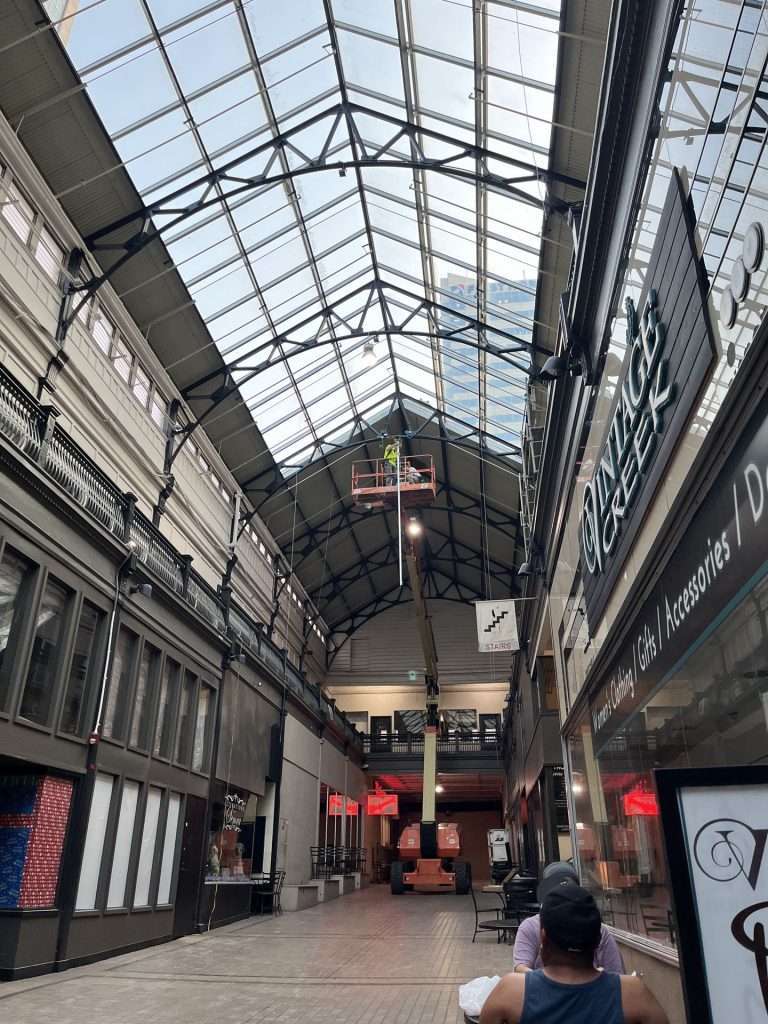 Aerial lift used for electrical work inside a historic marketplace atrium