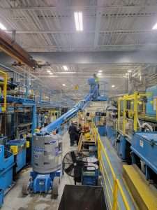 Boom lift used for overhead electrical work on a manufacturing production floor