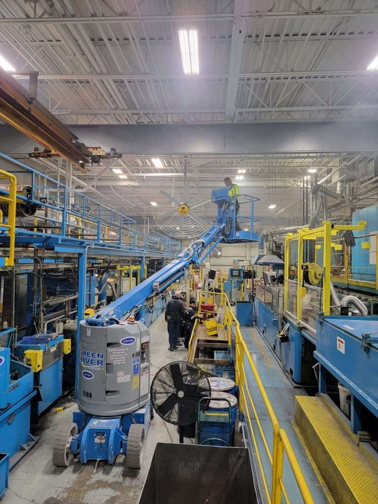 Boom lift used for overhead electrical work on a manufacturing production floor