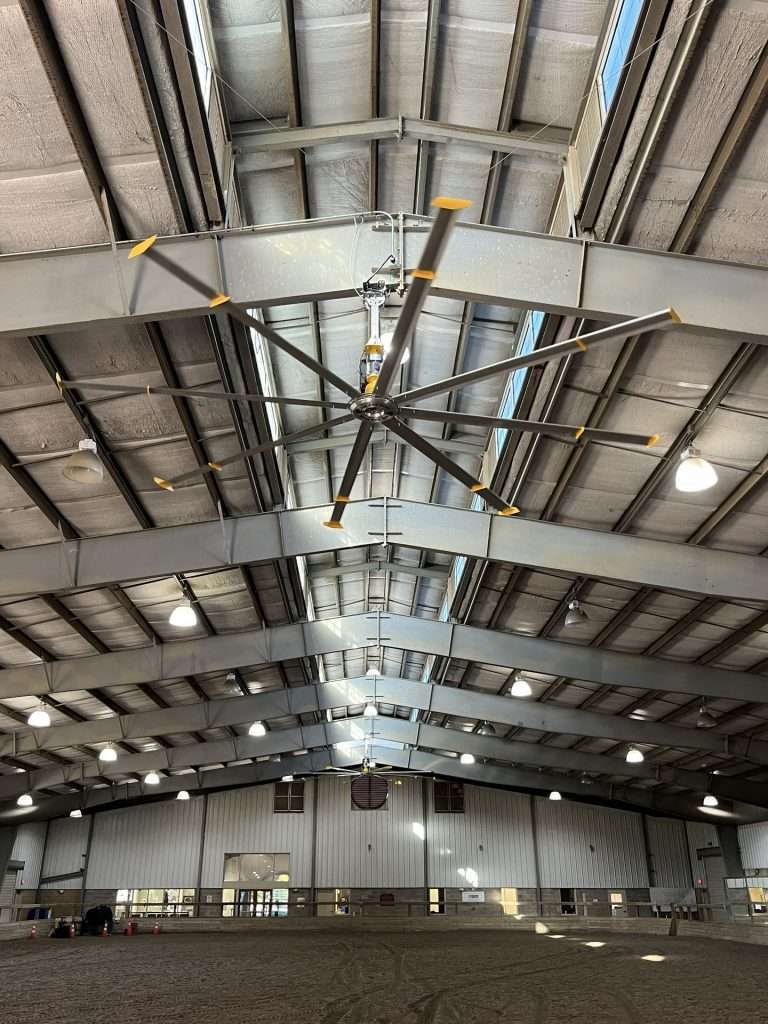 HVLS fan installed on the steel ceiling of an indoor arena