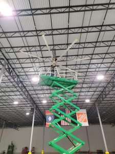 HVLS fan installation from a scissor lift in a distribution center
