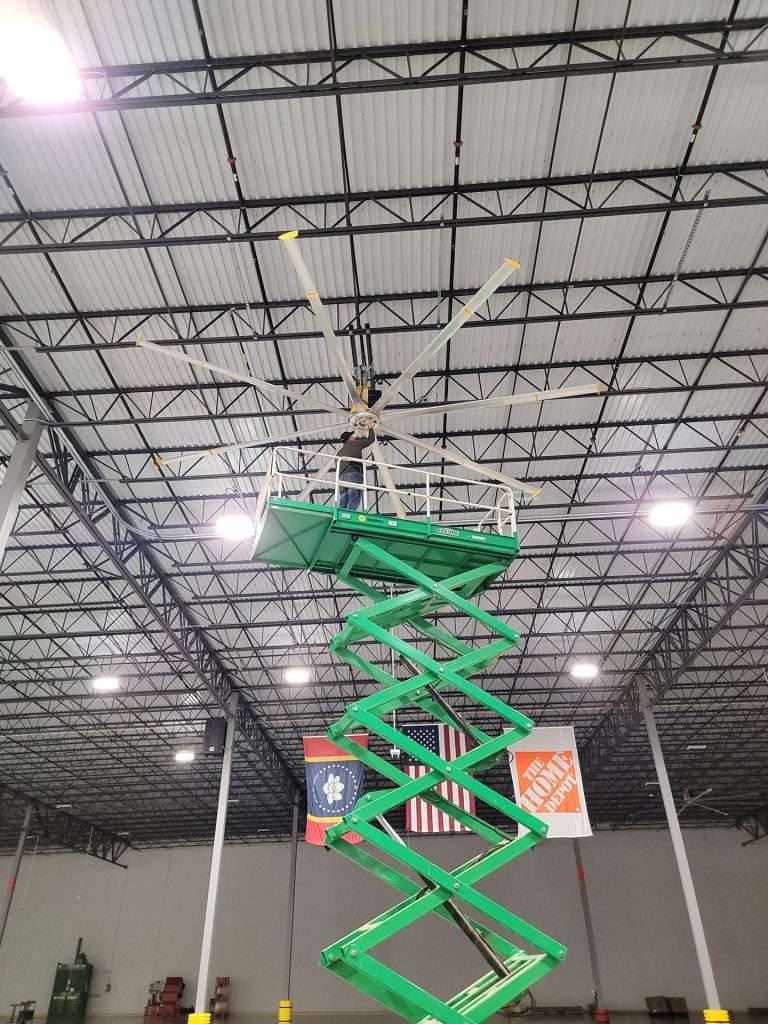HVLS fan installation from a scissor lift in a distribution center