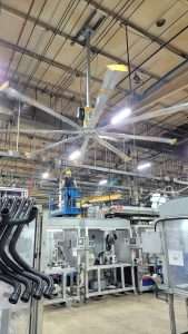 HVLS fan installation from a lift inside a manufacturing plant