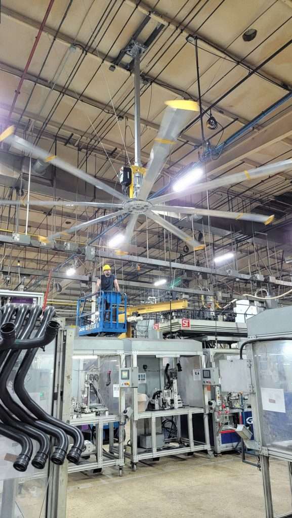 HVLS fan installation from a lift inside a manufacturing plant