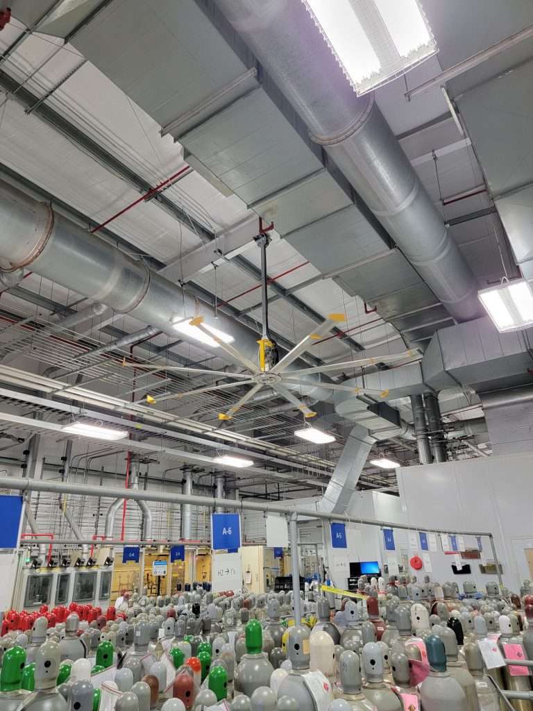 Industrial ceiling fan installed above a gas cylinder storage facility
