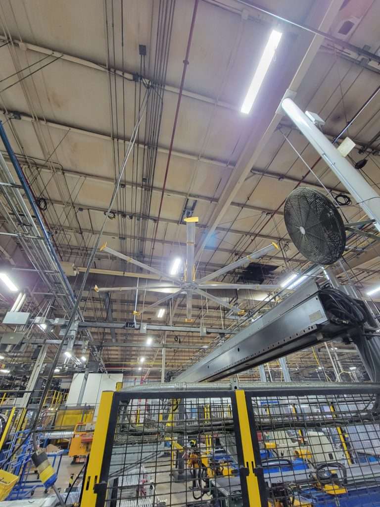 Industrial ceiling fan installed above a manufacturing production line