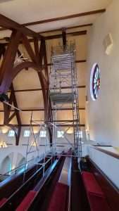 Scaffold tower set up in a church sanctuary for high ceiling lighting installation